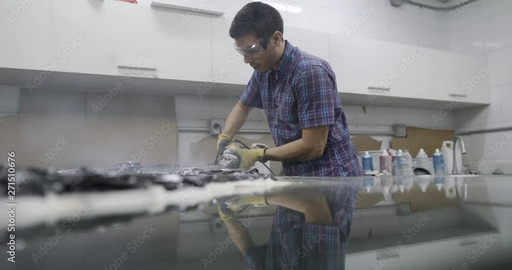 People at work in architecture design studio with plastic model and mock-up of new building. Busy young man working as artist in lab. Skilled manual worker with professional job