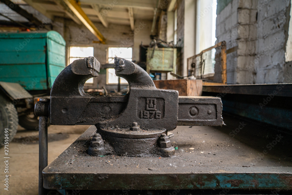 Old russian made vice attached on work desk in old factory Old russian made vice attached on work desk in old factory