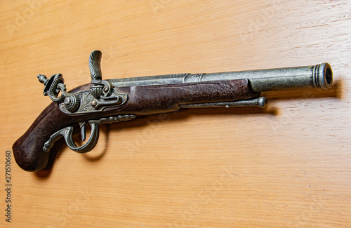 Antique gun pistol army danger Gun on wooden background