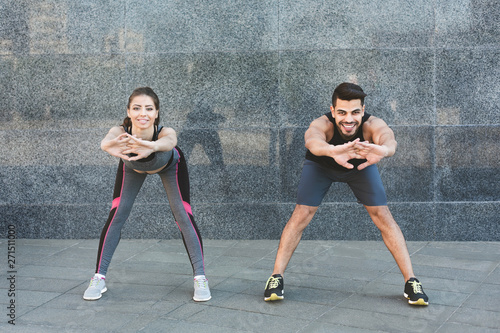 Happy fit couple exercising outdoor in the city