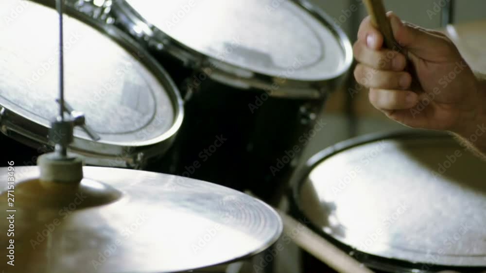Musical band. Group of musicians playing rock music on stage. Close-up shot of drummer playing the drums by hitting it with sticks. Slow motion. HD Musical band. Group of musicians playing rock music on stage. Close-up shot of drummer playing the drums by hitting it with sticks. Slow motion. HD