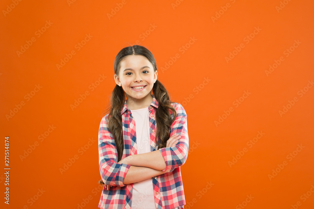 Upbringing versatile personality. Childhood concept. Girl child stand orange background. Happy childhood. Grow mentally and physically healthy child. Child care and psychology. Wellbeing and health Upbringing versatile personality. Childhood concept. Girl child stand orange background. Happy childhood. Grow mentally and physically healthy child. Child care and psychology. Wellbeing and health