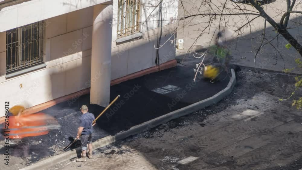 Workers laid asphalt in a residential area,time lapse Workers laid asphalt in a residential area,time lapse