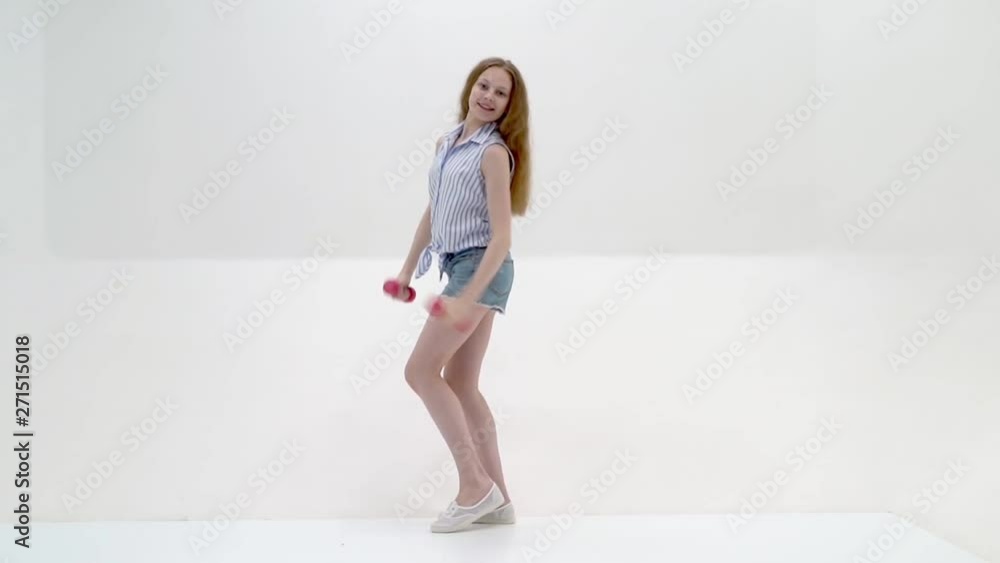 Teenage girl with dumbbells in hands Teenage girl with dumbbells in hands