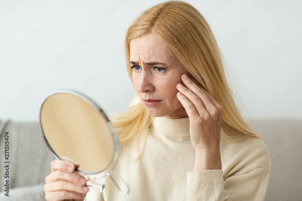 Anti-Wrinkle Skin Care. Sad Woman Looking In Mirror Anti-Wrinkle Skin Care. Sad Woman Looking In Mirror