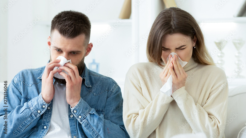 Flu Concept. Couple Blowing Noses In Tissues At Home Flu Concept. Couple Blowing Noses In Tissues At Home