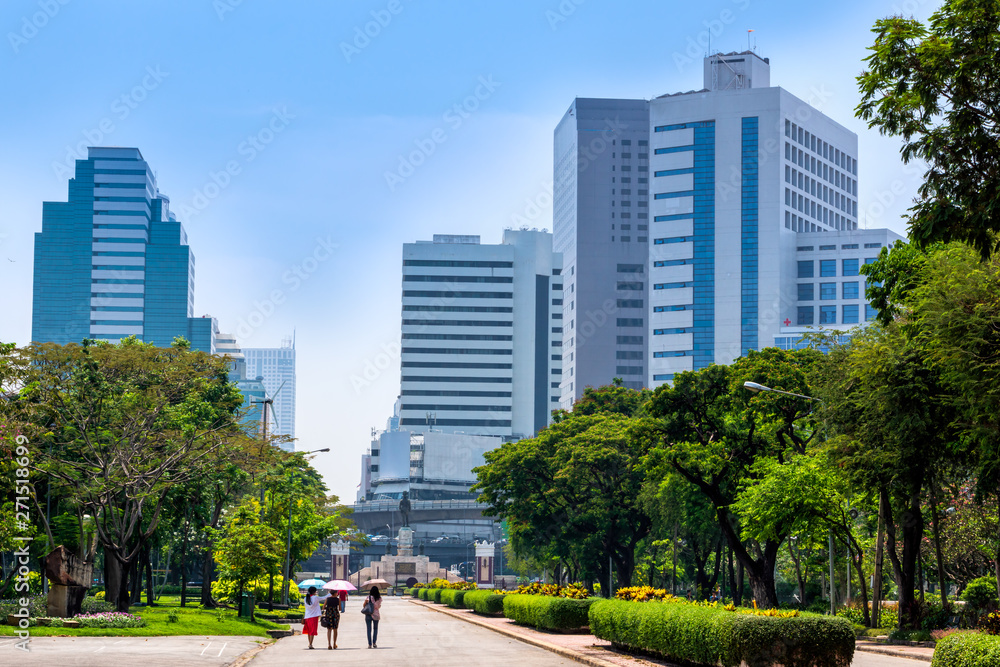 View at Bangkok skyscrapers from Lumpini city park, green oasis in modern busy city