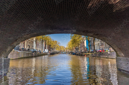 AMSTERDAM, NETHERLANDS - APRIL 14, 2019: Houses and Boats on Amsterdam Canal
