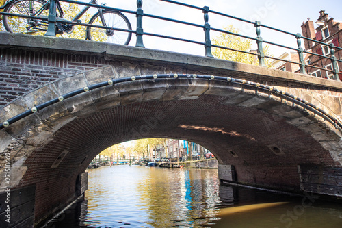 Photography AMSTERDAM, NETHERLANDS - APRIL 14, 2019: Houses and Boats on Amsterdam Canal