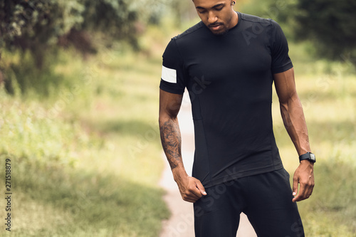 Fototapeta Naklejka Na Ścianę i Meble -  African-American Athlete In Blank T-Shirt Standing Outdoors