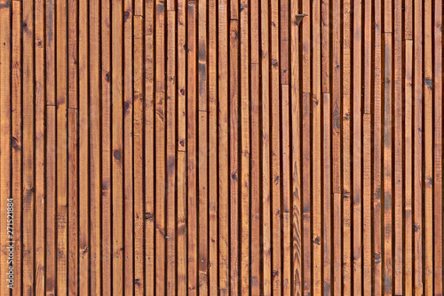 Smooth dark brown boards with knots. Background of wood slats. The texture of the wooden surface of the slats.