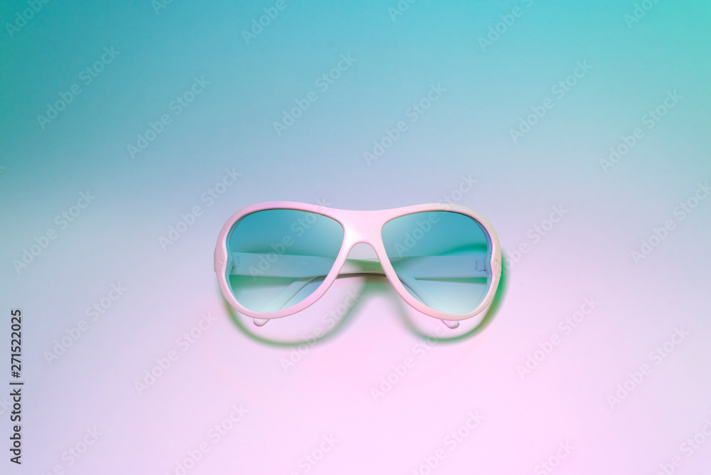 blue sunglasses on pastel color background. Creative fashion minimal concept