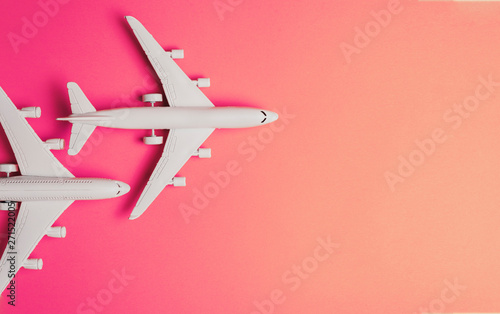 Two jet airplane on pastel color background. Travel around the world.