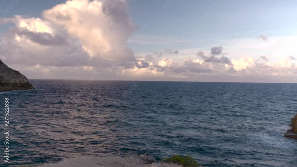 The remarkable view from Trou de Madame Coco in Guadeloupe showing an immense coastline bundled with blue water at sunset The remarkable view from Trou de Madame Coco in Guadeloupe showing an immense coastline bundled with blue water at sunset