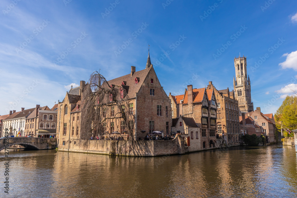 Bruges, Belgium - APRIL 05, 2019: Historic medieval buildings and canal in the old town of Bruges