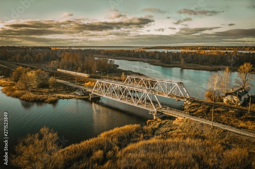 Railroad bridge over the river with train passing by