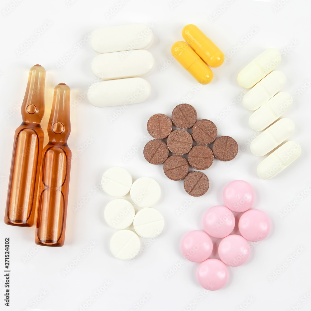 medicinal tablets, ampules for injections on white background medicinal tablets, ampules for injections on white background