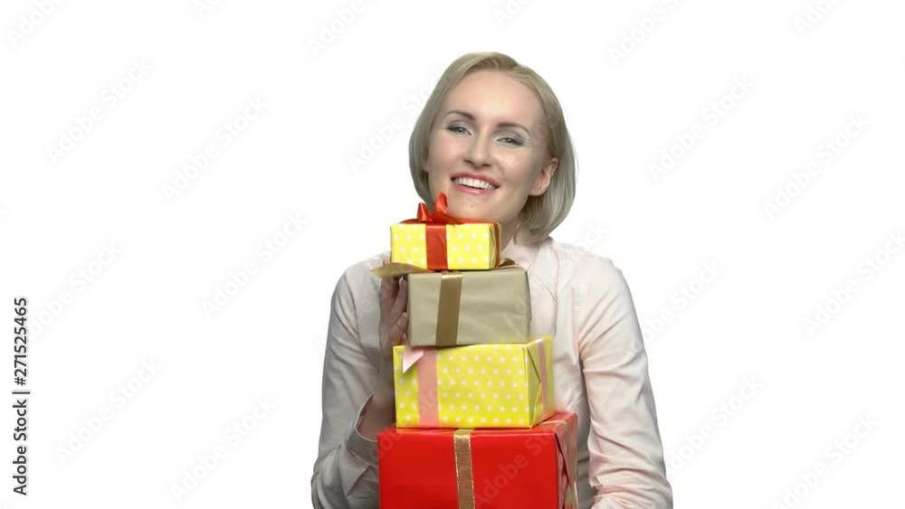 Happy woman with pile of gift boxes. Satisfied business woman holding stack of gift boxes. Holiday surprise concept. Happy woman with pile of gift boxes. Satisfied business woman holding stack of gift boxes. Holiday surprise concept.