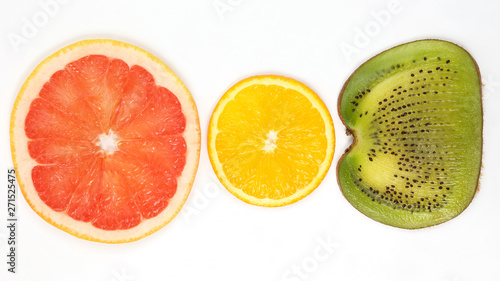 across sliced kiwi  orange and grapefruit on white background