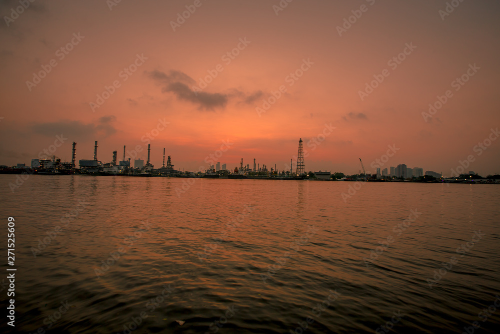 Blurred natural background of the morning sunshine along the river, breathtaking views (cargo ship, oil refinery), boat transportation