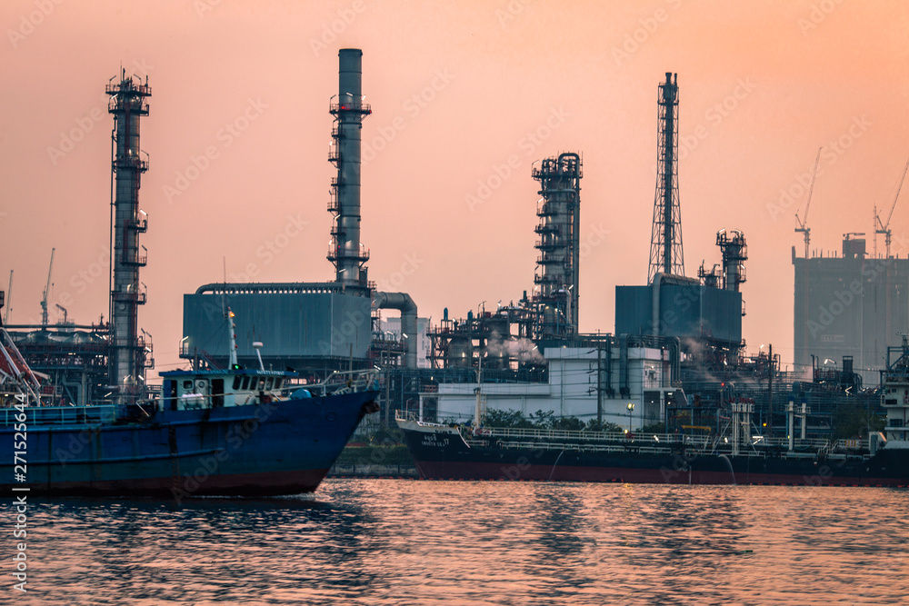 Blurred natural background of the morning sunshine along the river, breathtaking views (cargo ship, oil refinery), boat transportation