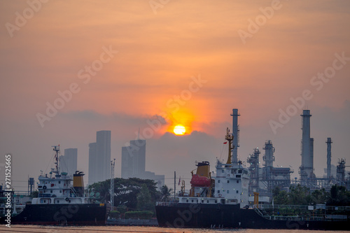 Blurred natural background of the morning sunshine along the river, breathtaking views (cargo ship, oil refinery), boat transportation © bangprik