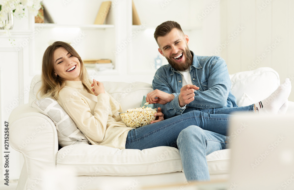 Young Couple Laughing Watching Comedy Movie Online Young Couple Laughing Watching Comedy Movie Online