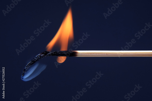 burning and Smoking wooden match on dark background.