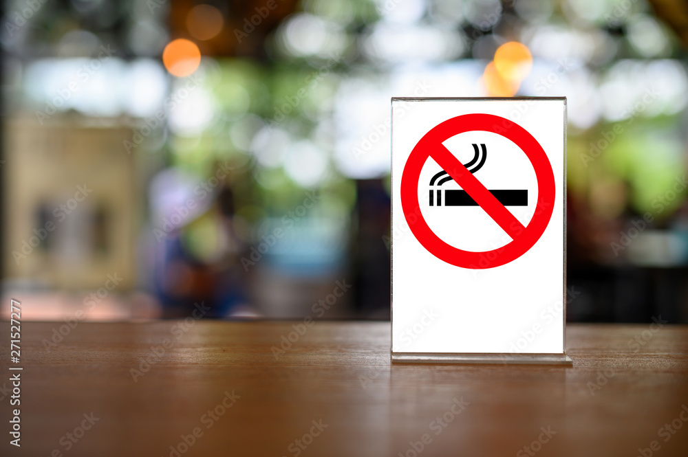 no smoking sign with shopping place background on wooden table no smoking sign with shopping place background on wooden table