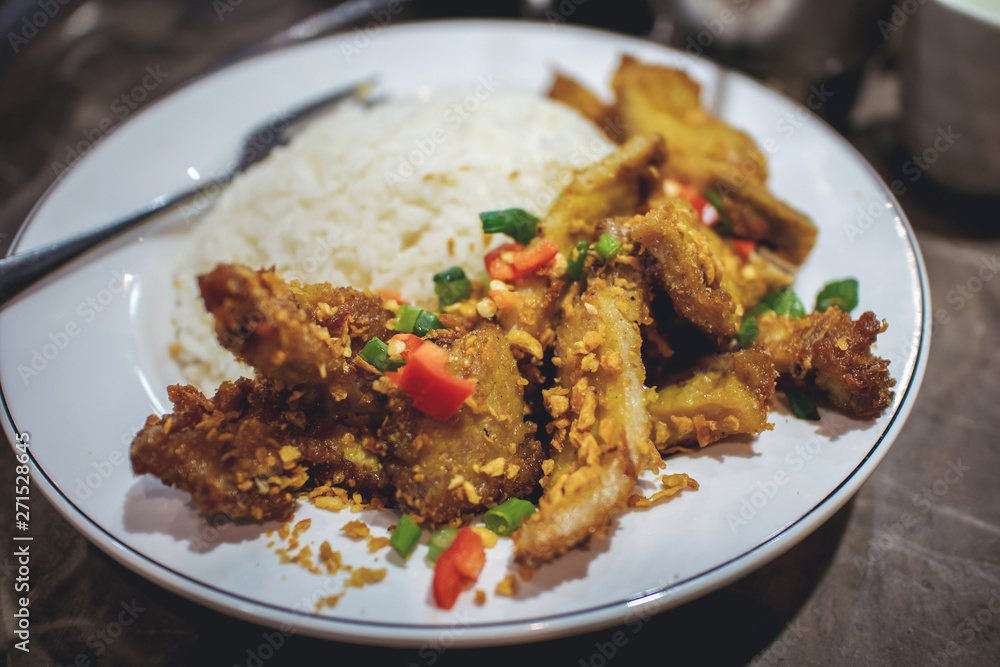Pork belly fried with pepper, chilli and garlic on stream jasmine rice for lunch or dinner, traditional Chinese and Thai food, street food Pork belly fried with pepper, chilli and garlic on stream jasmine rice for lunch or dinner, traditional Chinese and Thai food, street food