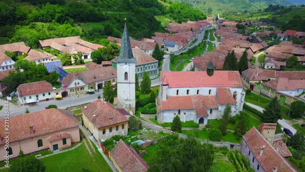 Beautiful aerial view of houses and tower church of a green romanian village. Beautiful landscape in summer day. 4k Beautiful aerial view of houses and tower church of a green romanian village. Beautiful landscape in summer day. 4k