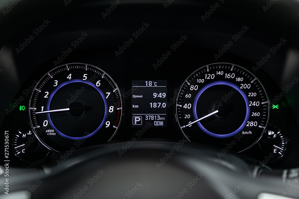 New sports car speedometer, dashboard and tachometer  with white backlight and other buttons.