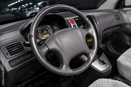Close-up of the dashboard, speedometer, tachometer and steering wheel. Luxurious car interior details. © Виталий Сова