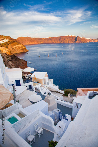 beautiful Oia town on Santorini island, Greece. Traditional white architecture and greek orthodox churches with blue domes over the Caldera, Aegean sea. Scenic travel background