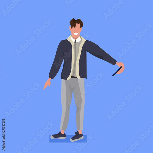 man taking selfie photo on smartphone camera casual male cartoon character posing blue background flat full length vector illustration