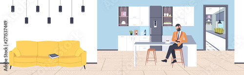 businessman sitting at counter man using smartphone mobile app communication concept modern coffee point kitchen interior flat full length horizontal
