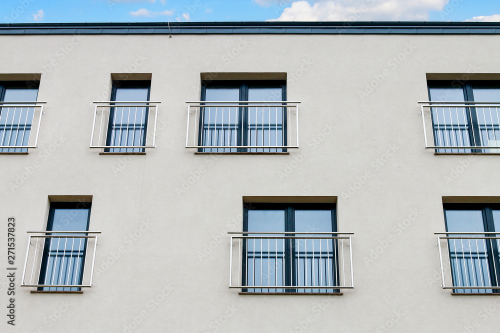 Block of flats facade with windows.