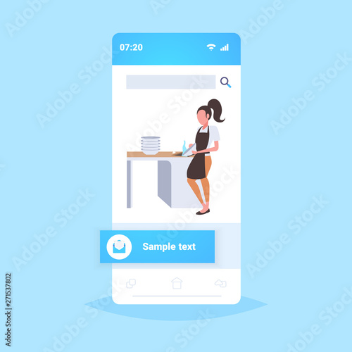 woman washing dishes housewife wiping plates on kitchen dishwashing concept girl in apron doing housework smartphone screen mobile app flat full length