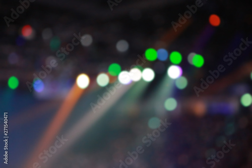 Blurred Concert light with colored spotlights and smoke.