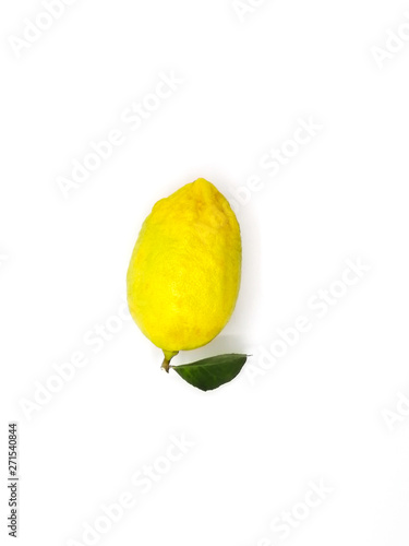 Top view of whole fresh ripe lemon with leaf isolated on white background