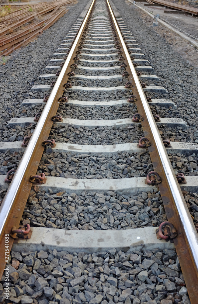 Steel support rails with concrete sleepers strewn with gravel Steel support rails with concrete sleepers strewn with gravel