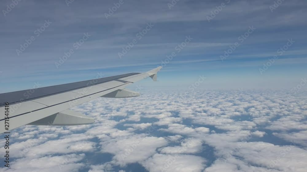 Speed Up Shot Of Airplane Wing Flying In Beautiful Blue Sky Over The Clouds - 4K 60fps Speed Up Shot Of Airplane Wing Flying In Beautiful Blue Sky Over The Clouds - 4K 60fps
