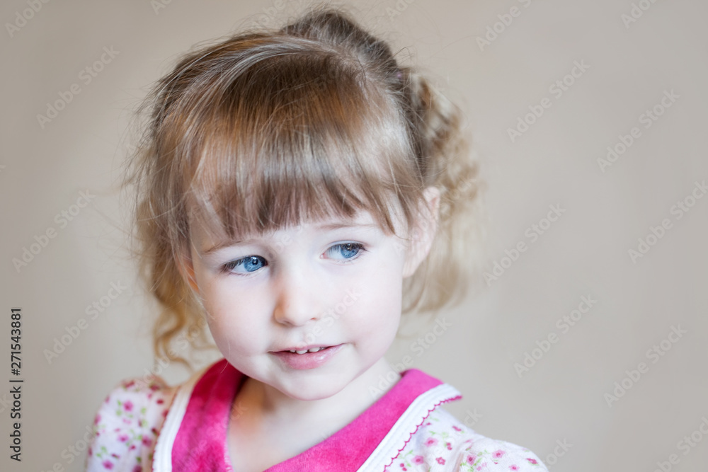 beautiful white child girl face closeup portrait on beige wall background beautiful white child girl face closeup portrait on beige wall background
