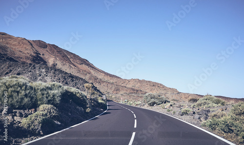 Vintage toned scenic winding mountain road seen through the windshield, Tenerife, Spain.