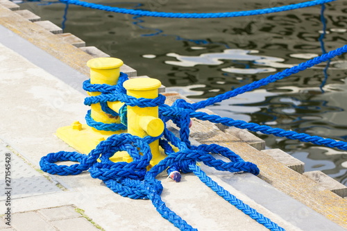 Blue rope and mooring bollard in seaport, yachting concept © ratmaner