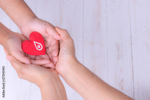 Wallpaper Mural Woman and child hands holding red heart  for blood donation concept. World blood donor day, World heart day,world health day concept. Copy space for text. Torontodigital.ca