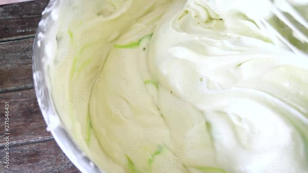 Pouring green colour on white butter cream. Pouring green colour on white butter cream.