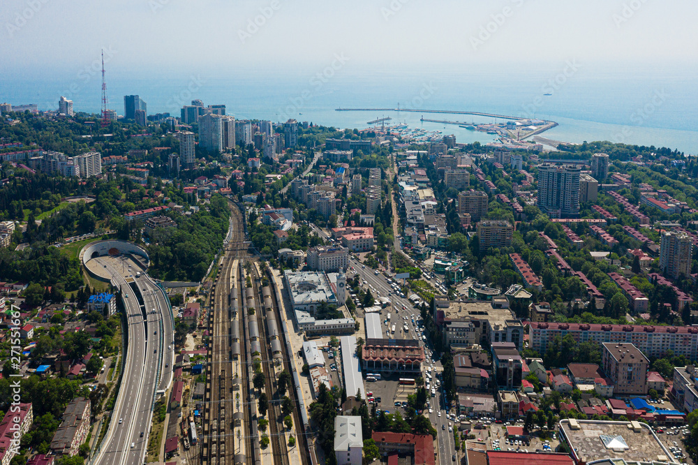 Aerial video shooting The center of the city of Sochi with a bird s eye view. Blue sky. Blue sea. Urban infrastructure. Houses,roads,power lines. Densely populated area. Residential area. City view.