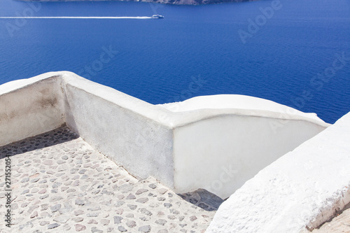 beautiful Oia town on Santorini island  Greece. Traditional white architecture and greek orthodox churches with blue domes over the Caldera  Aegean sea. Scenic travel background