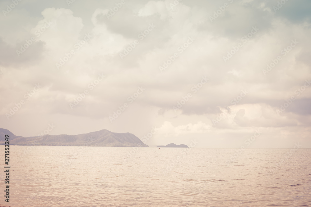 Background image of a beautiful sea horizon with clouds above it in Thailand, toned. Background image of a beautiful sea horizon with clouds above it in Thailand, toned.